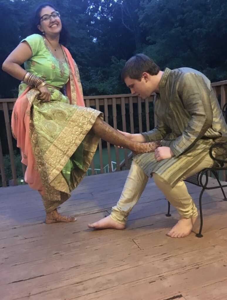 My husband looking for his name in henna.