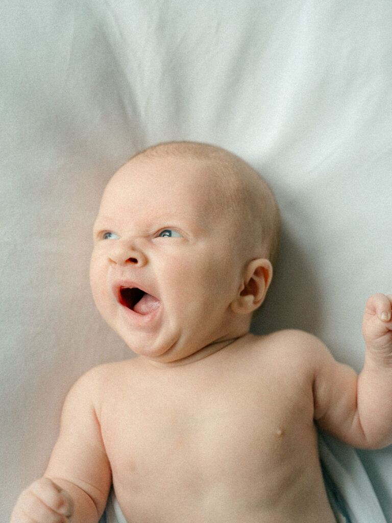 newborn baby yawns during his newborn session