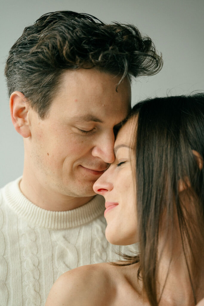 new parents snuggle together during a newborn session