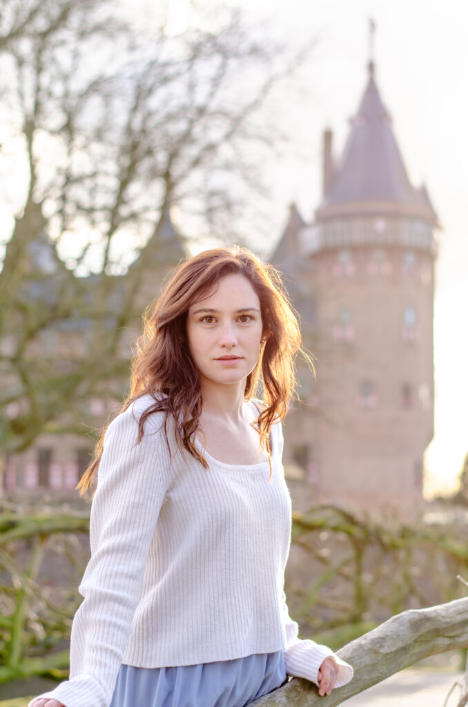 woman looks out over a bridge at kasteel de haar in the netherlands