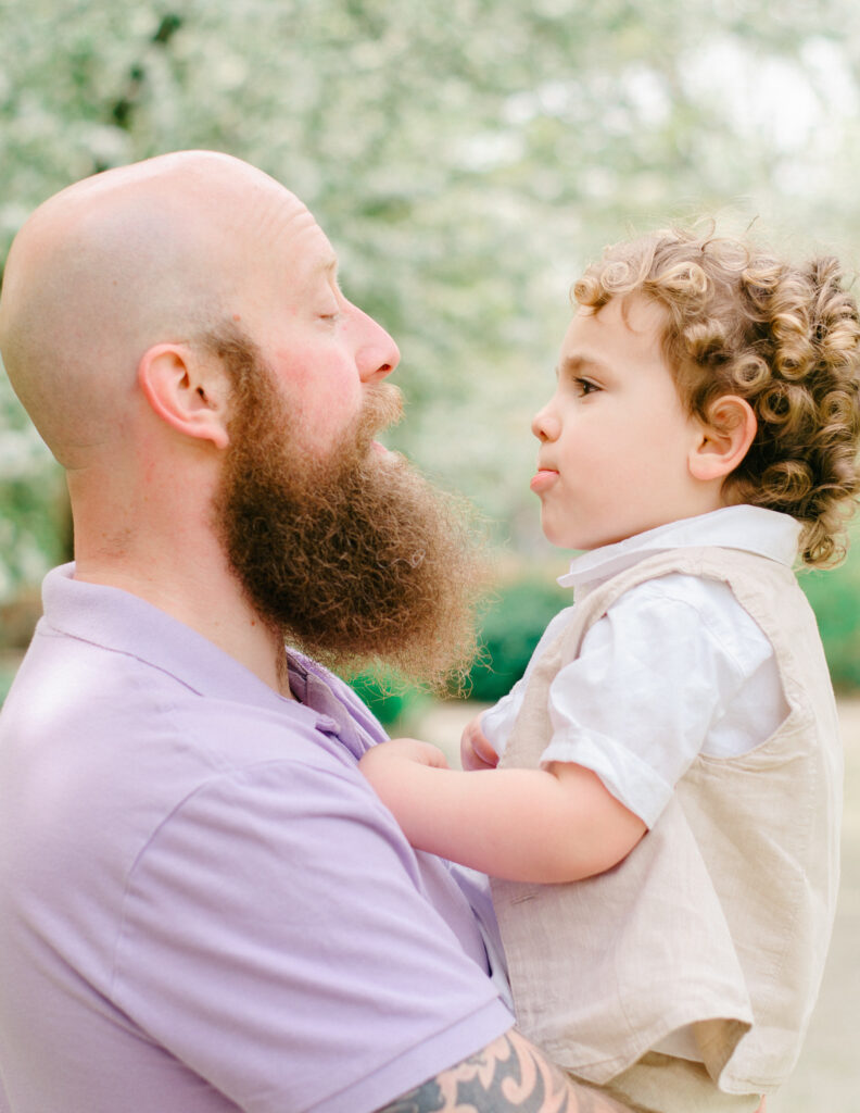 Father and son stick their tongues out at each other.