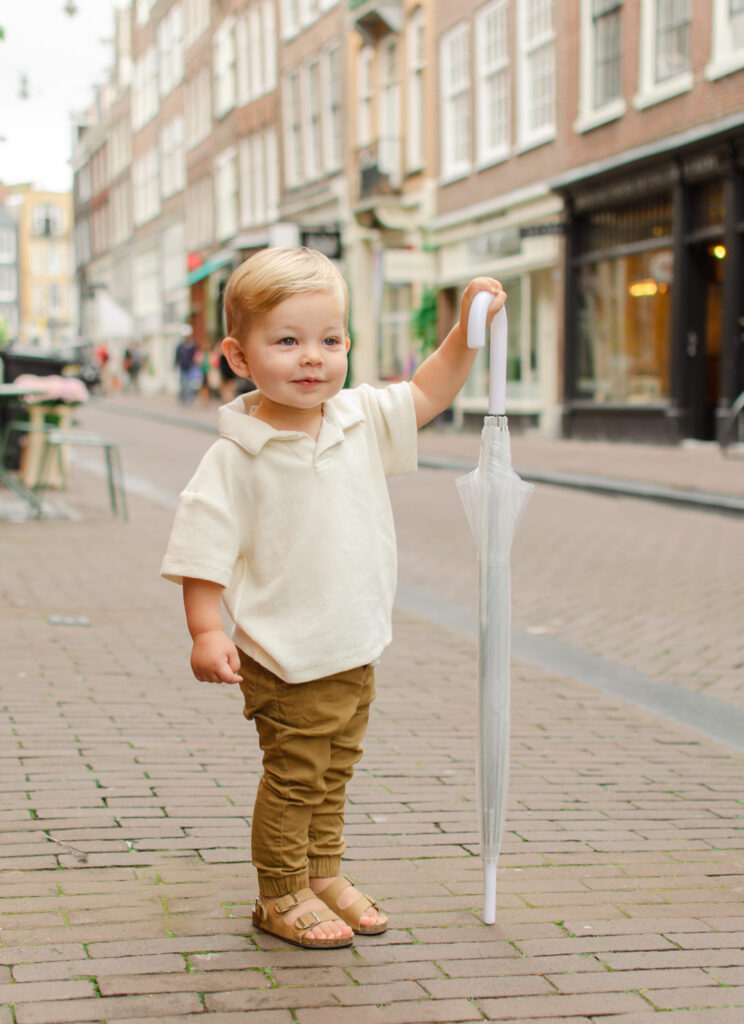 toddler with clear umbrella in amsterdam