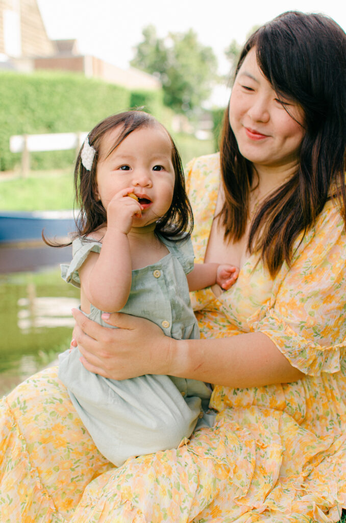 Lifestyle image of daughter sitting on mom's lap in Giethoorn, near their Airbnb.