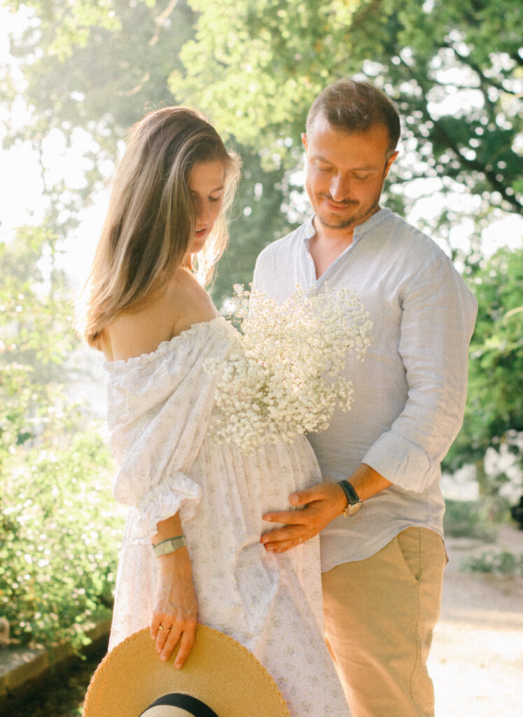 Peaceful maternity session among the trees and flowers of the Miracle Garden.