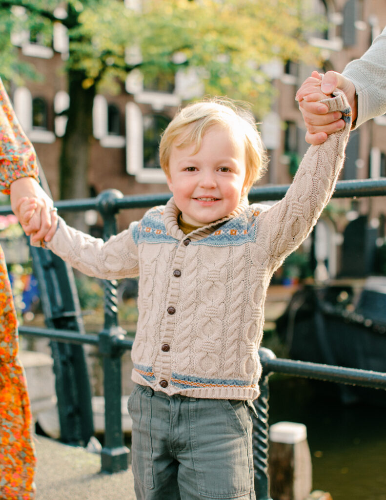 Little boy smiles during an Amsterdam photo session in the Jordaan neighborhood.