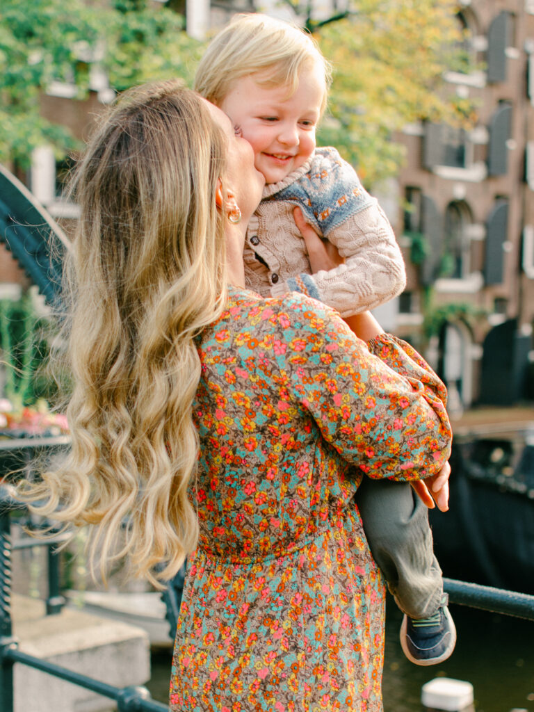 Mum hugs her son in the Amsterdam sun.
