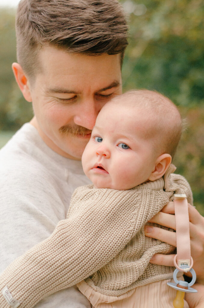 Close up image of a father and his baby girl in the fall.