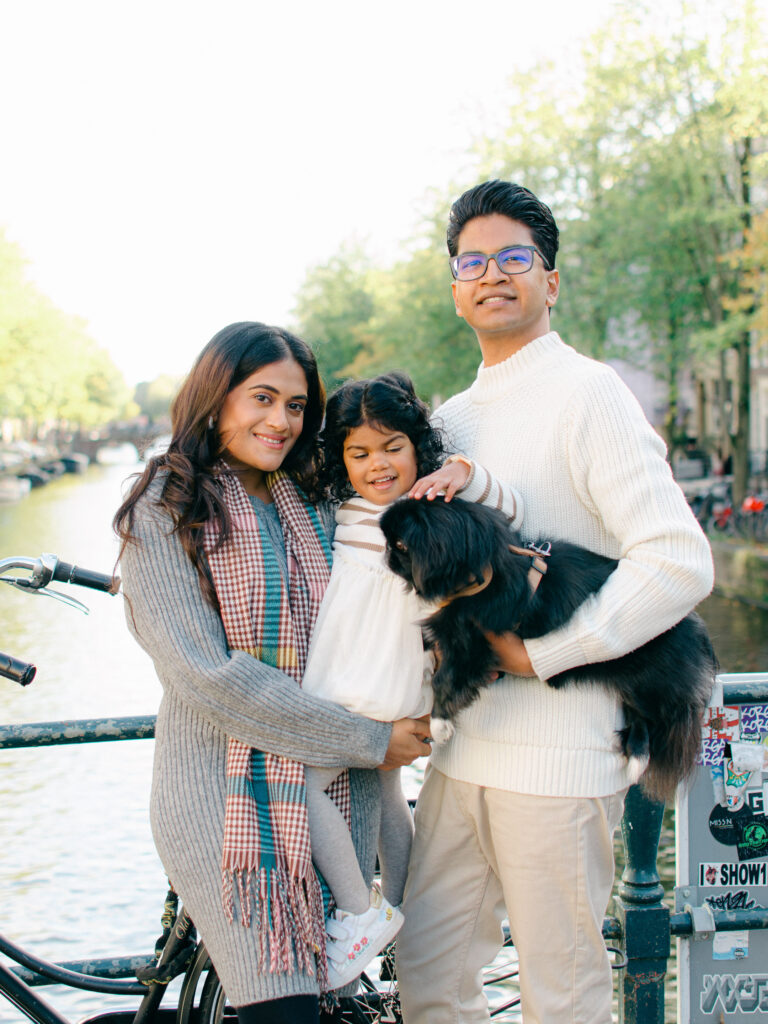 Soft and elegant portrait of a small family in Amsterdam with their puppy.
