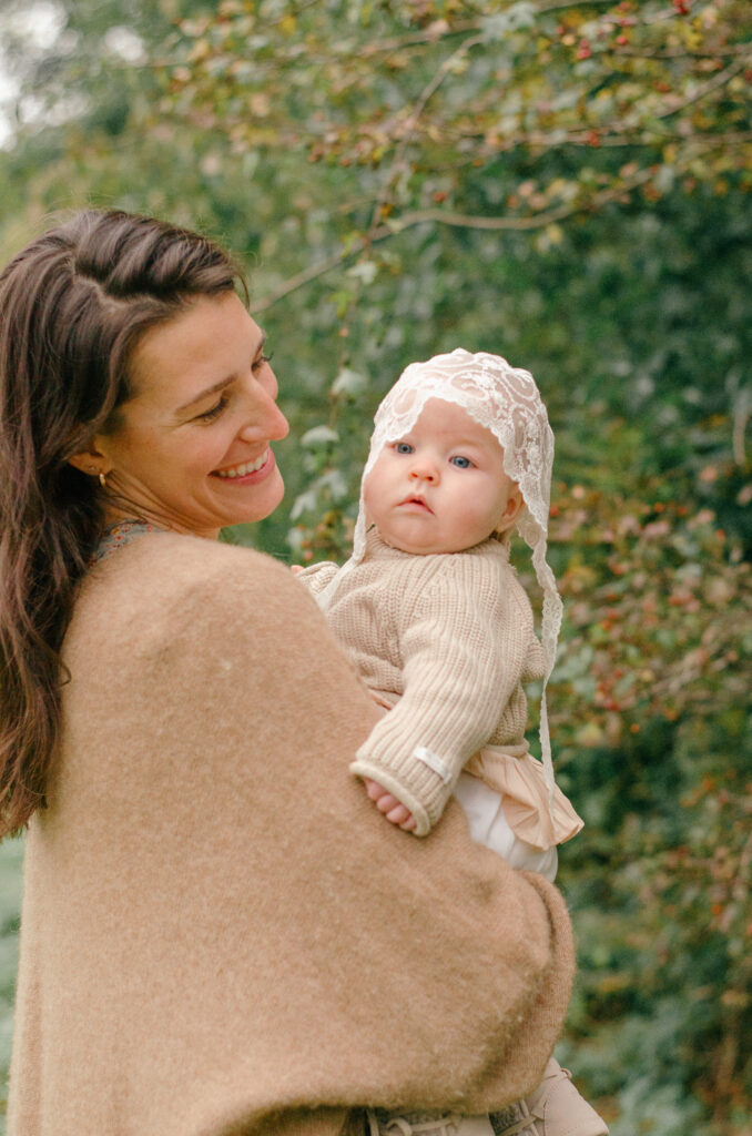 Mother and daughter spinning under the fall leaves.