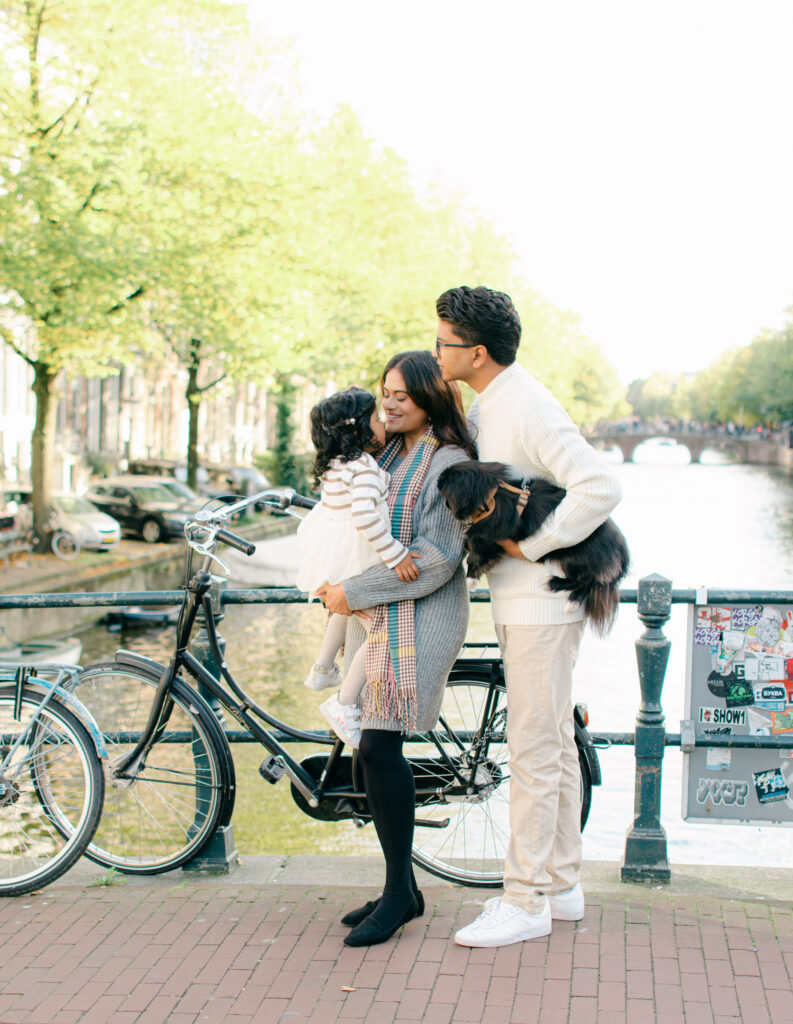 Natural light family photo with historic Amsterdam in background.