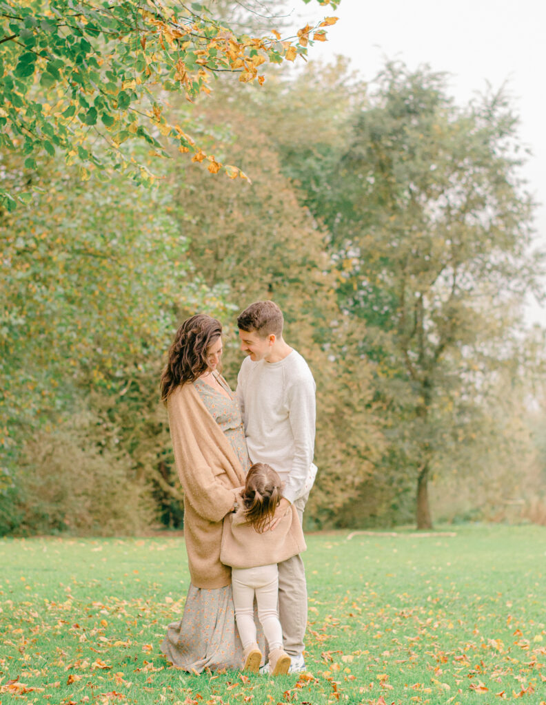 Cozy family photo with fall foliage in Amsterdam.