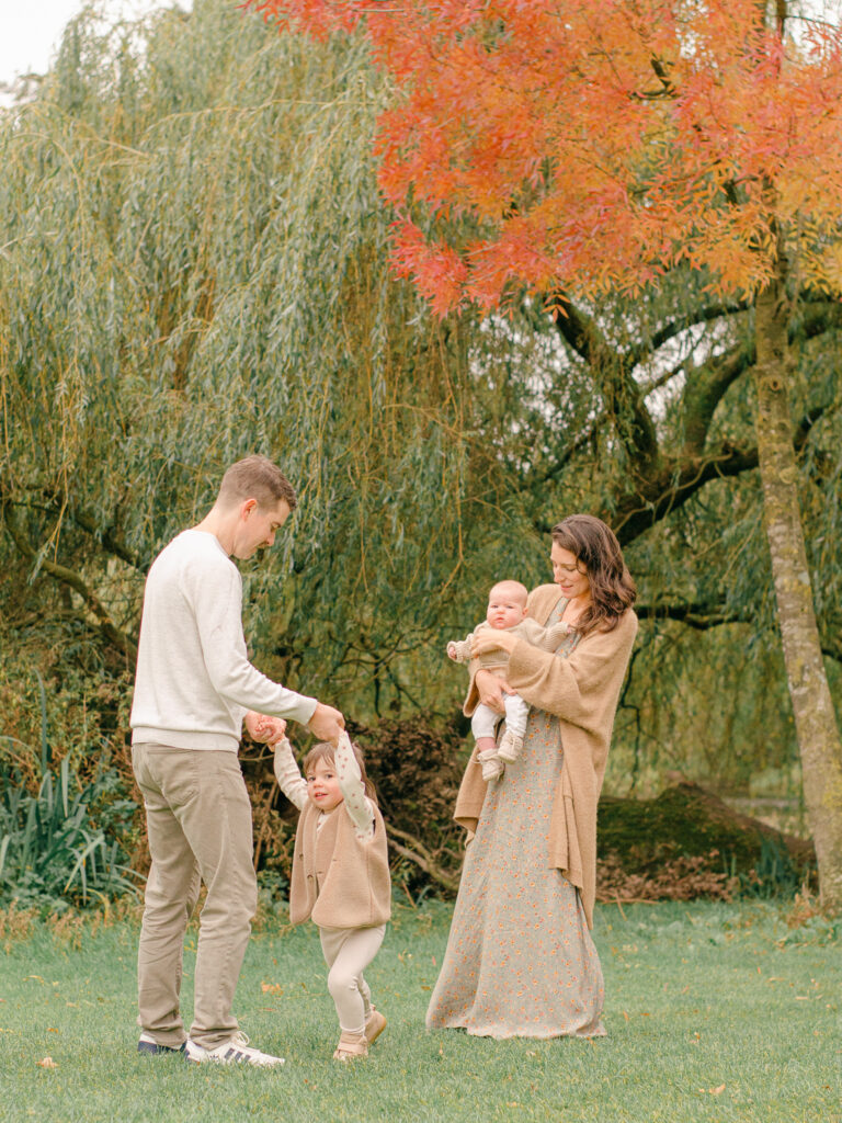 Candid photo of a family of four playing in Vondelpark.