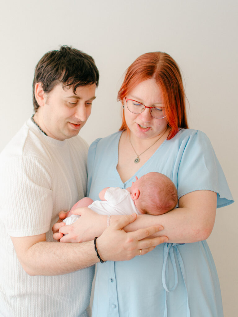 Parents cradling newborn in studio in Amsterdam West.