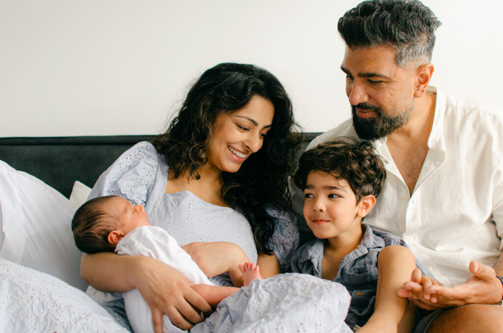 Natural moments of family bonding with newborn.