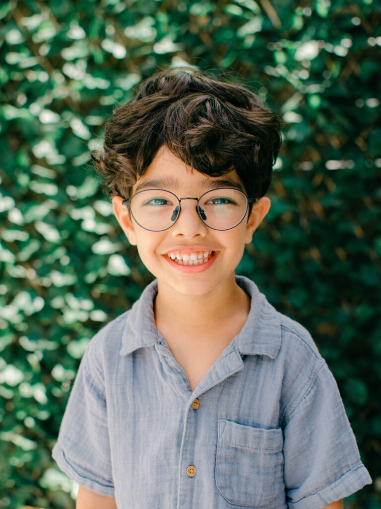 Natural light portrait of a little boy in the outside garden.