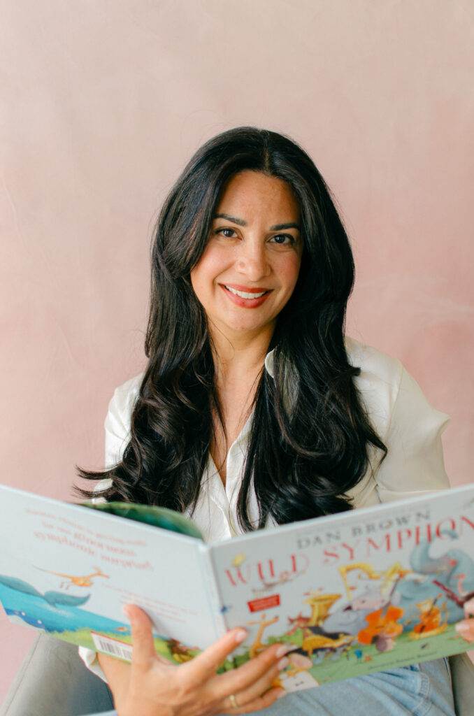 Amsterdam sleep consultant poses reading a bedtime story for her professional, feminine headshots. 
