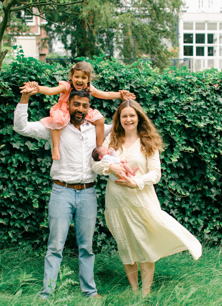 Family smiles during a newborn photoshoot at their house in Amsterdam.