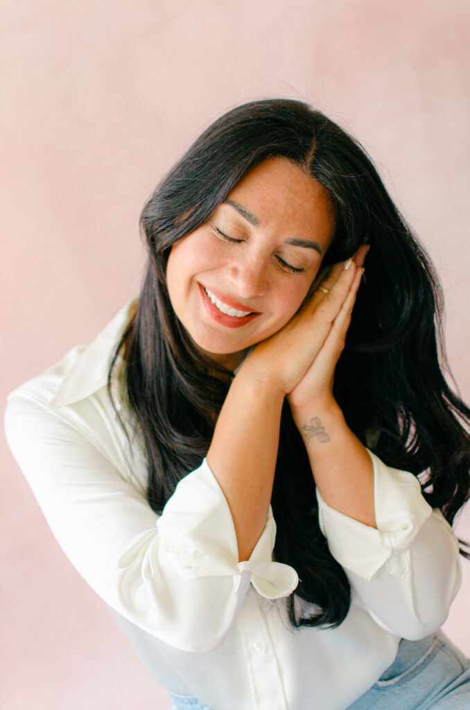 Beautiful entrepreneur headshot of a sleep consultant pretending to sleep peacefully.