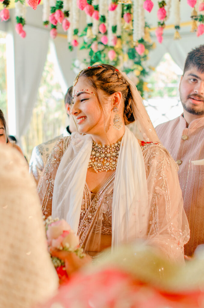 Indian bride in traditional wedding lehenga.
